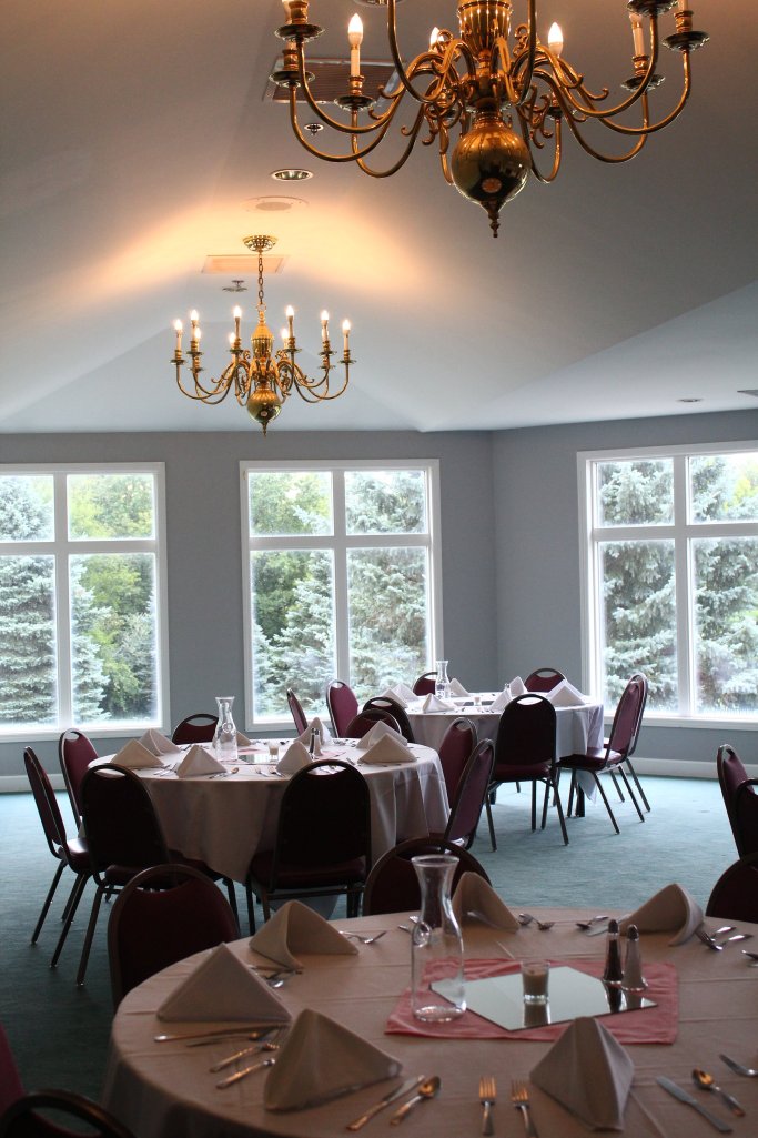 banquet table settings against windows 