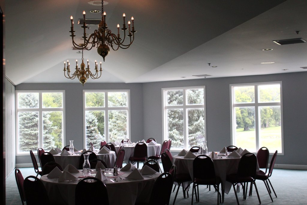 banquet tables with chandeliers above seating